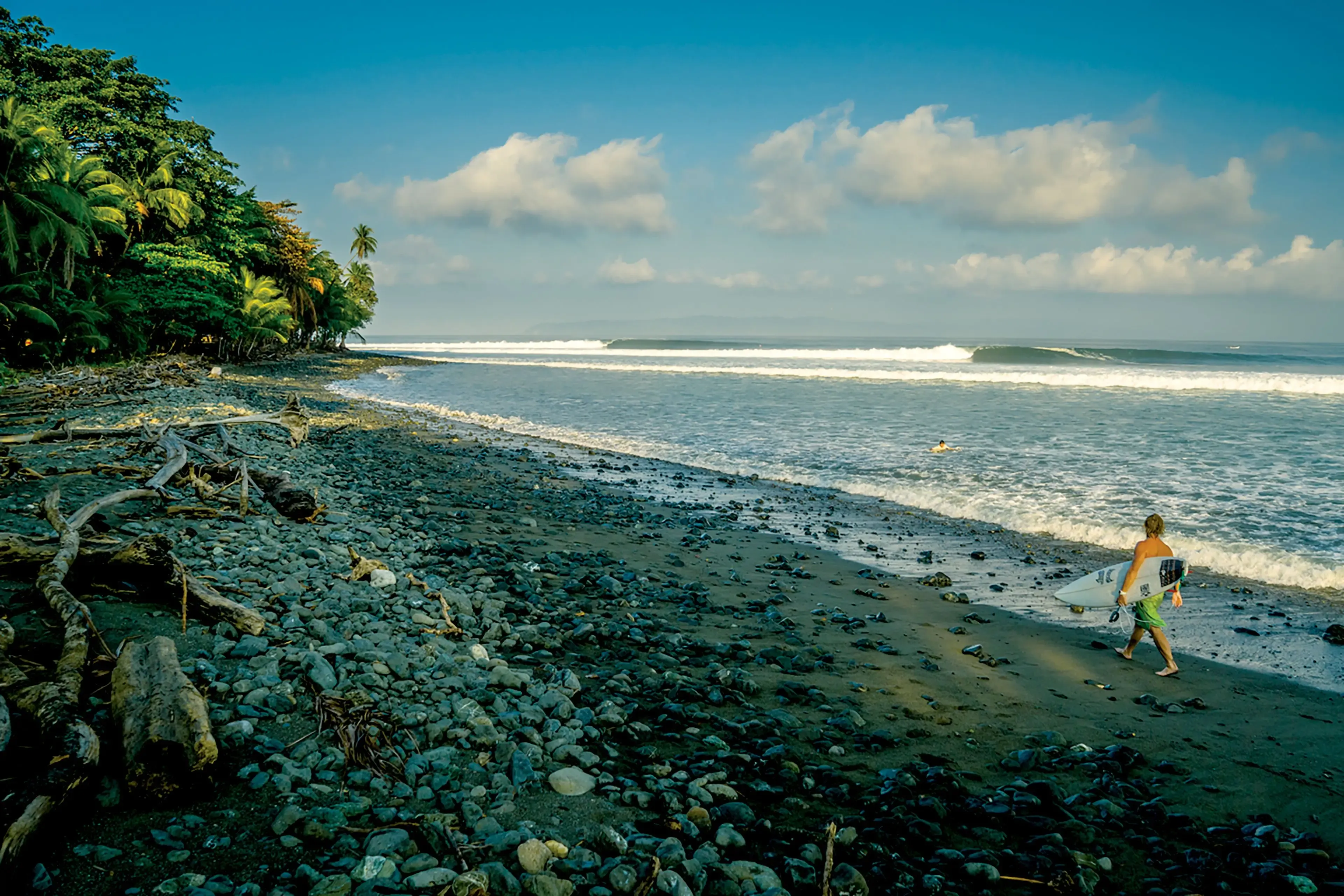 The Pavones left-hand point break, waves peeling along the rocky point, southern Costa Rica