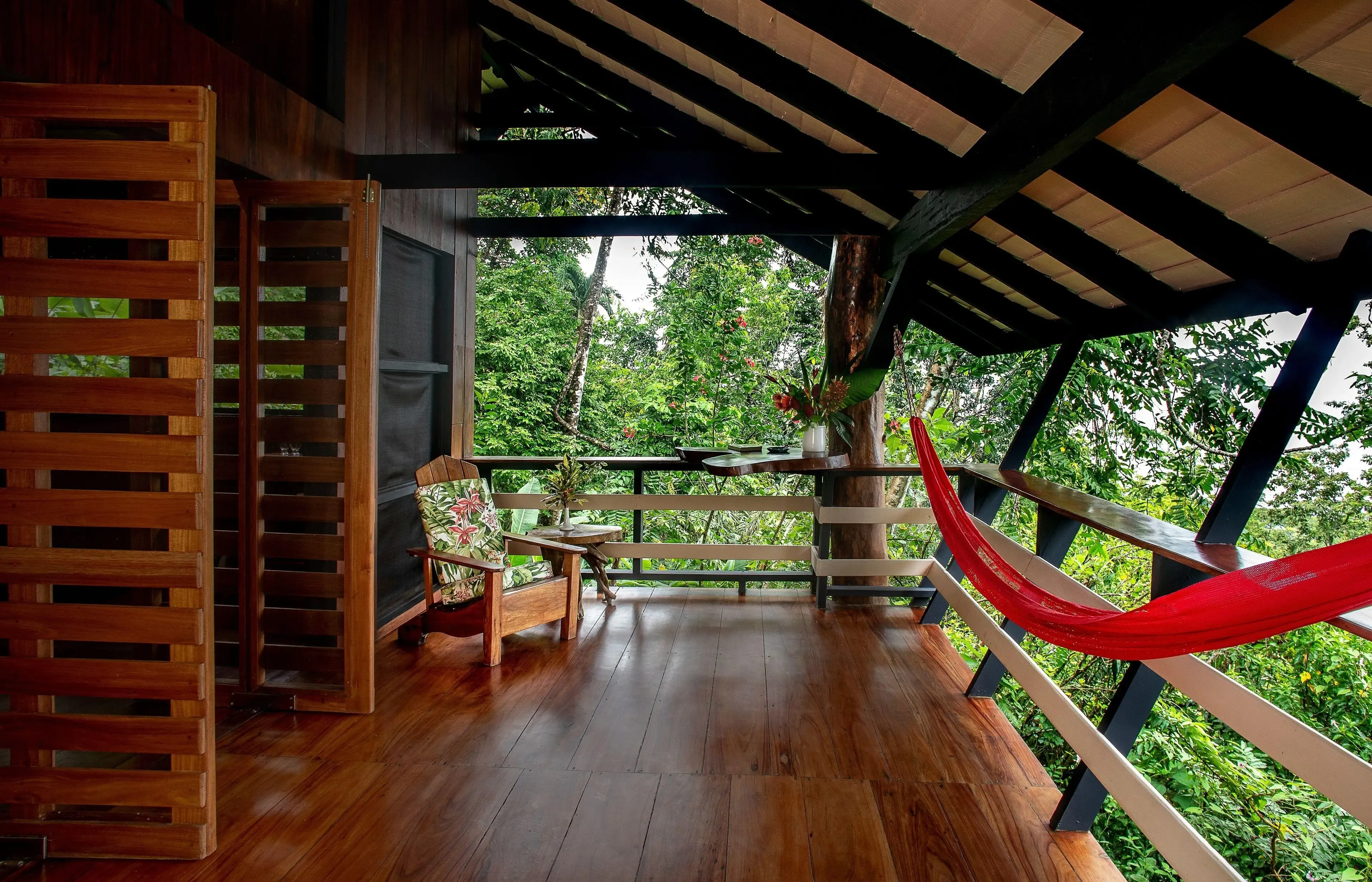 A shaded deck at a Pavones surf lodge looking into the jungle between surf sessions
