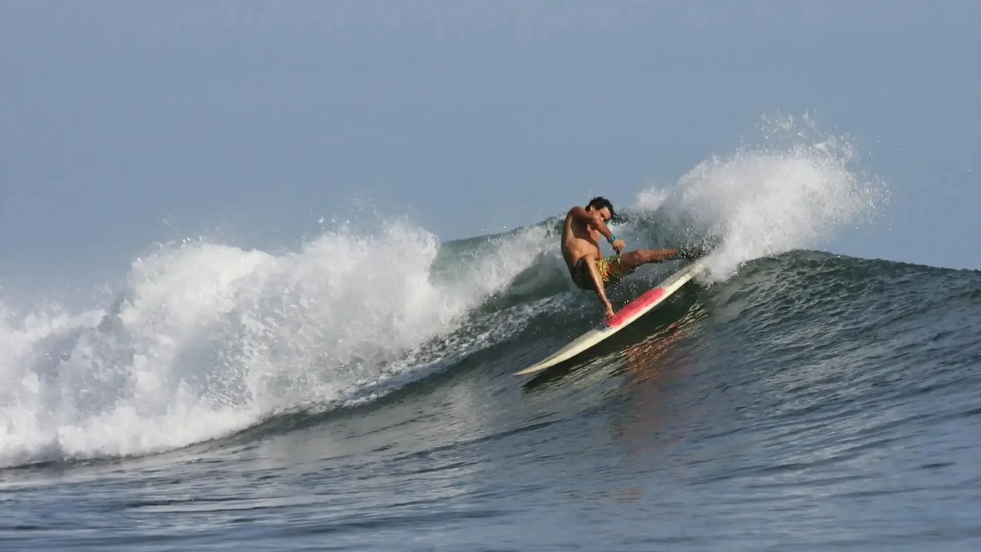 Surfer setting up a turn on the open wall at the Pavones left-hand point break, southern Costa Rica