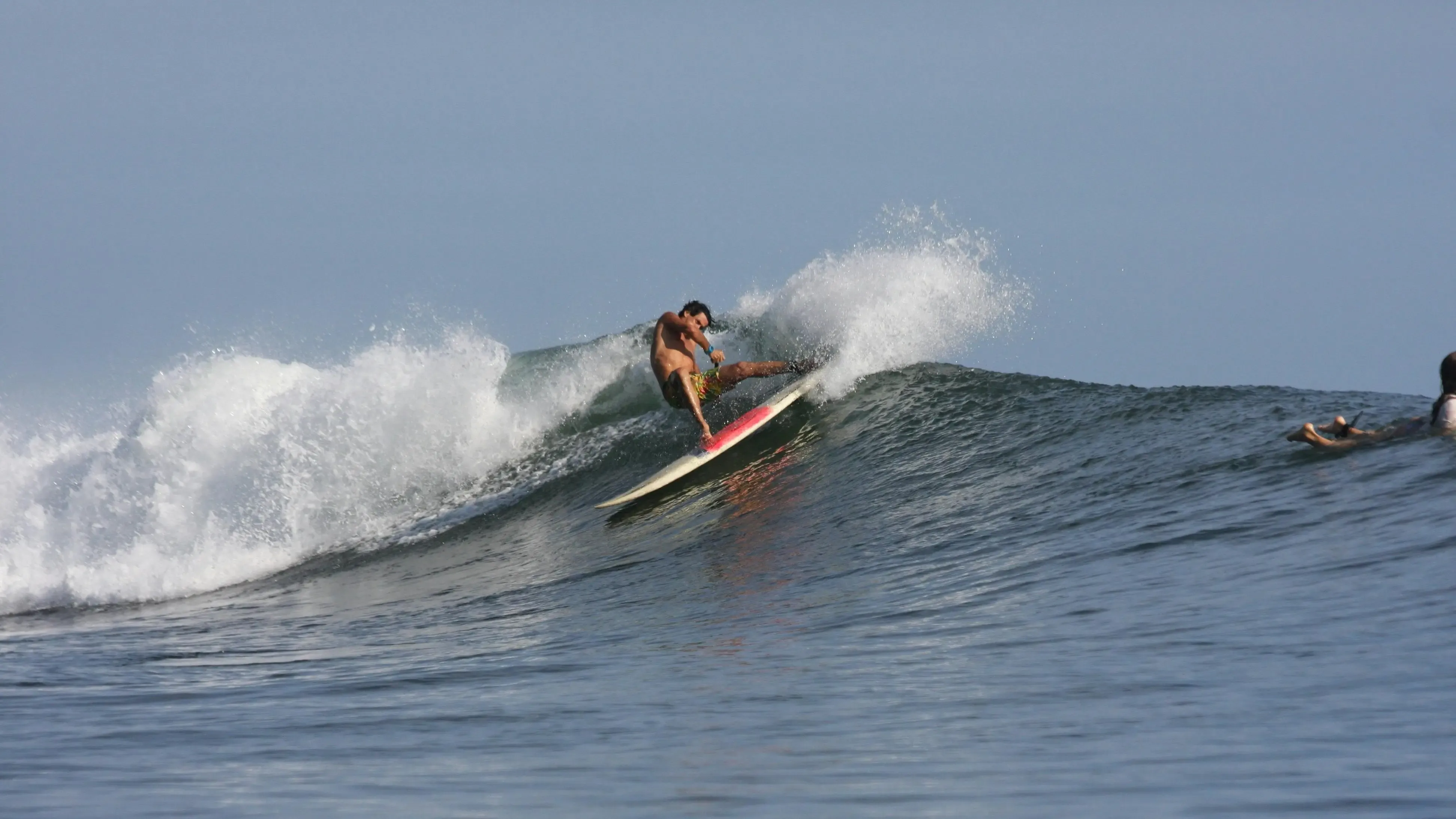 Surfer setting up a turn on the open wall at the Pavones left-hand point break, southern Costa Rica