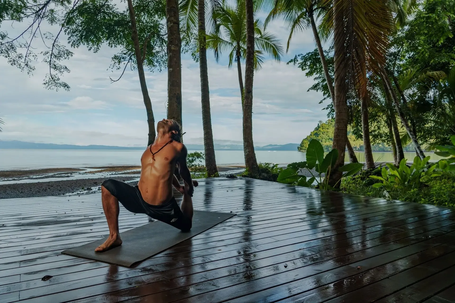 Outdoor yoga class at a surf camp in Pavones Costa Rica, surrounded by tropical jungle